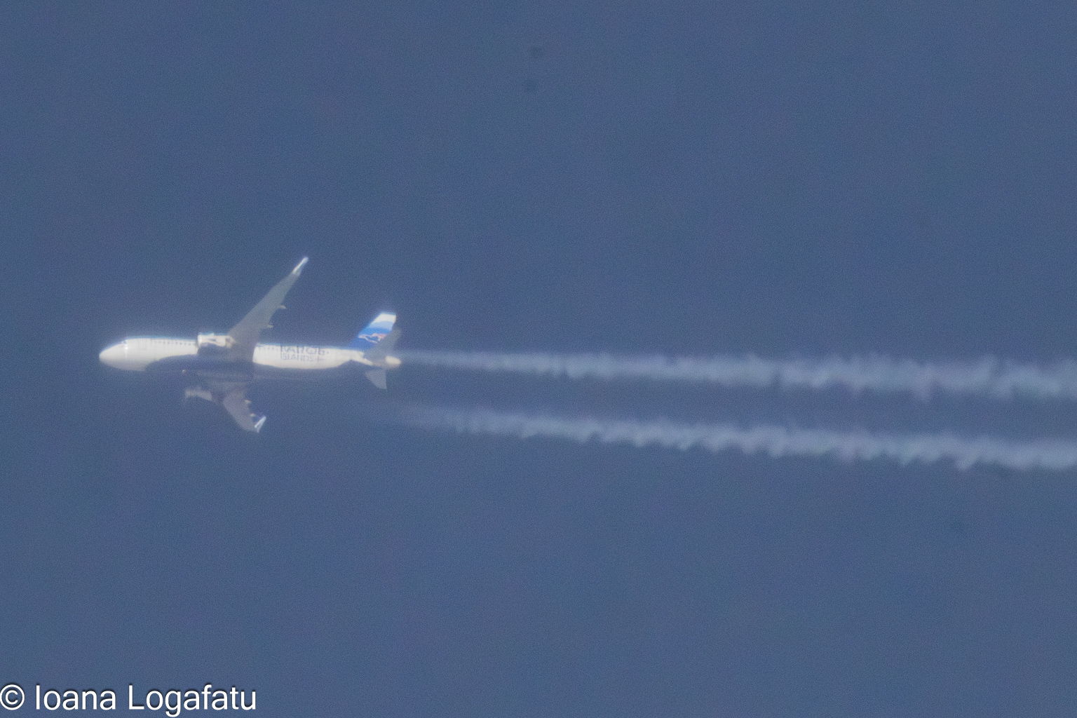 Jet soaring through clear blue skies above